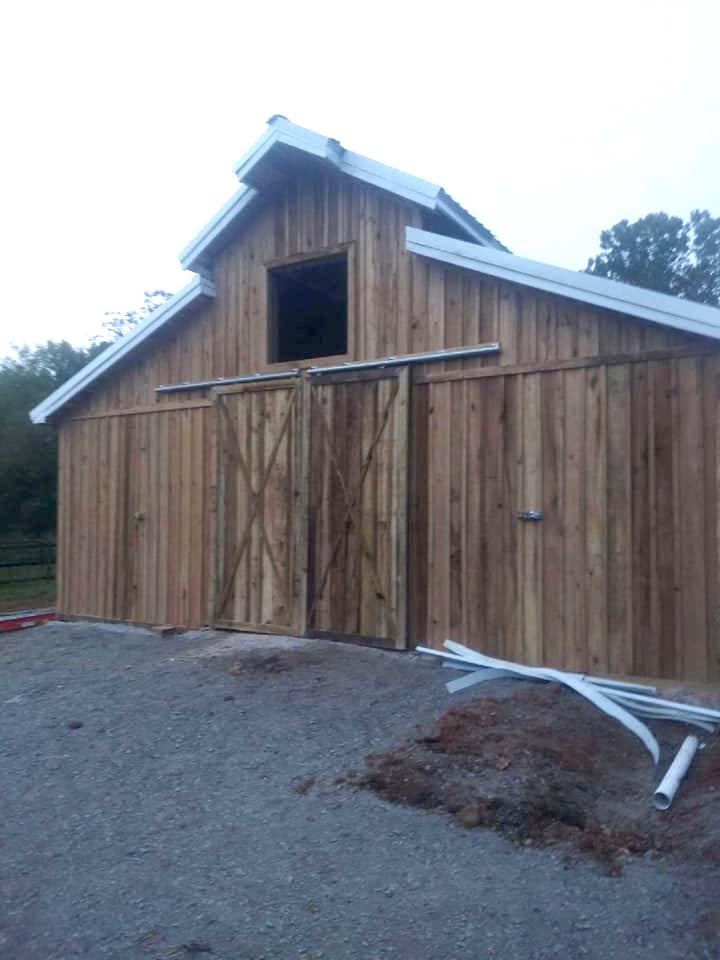 Photo of covered outdoor storage area large enough to store 2 tractors or other farm equipment and suppies