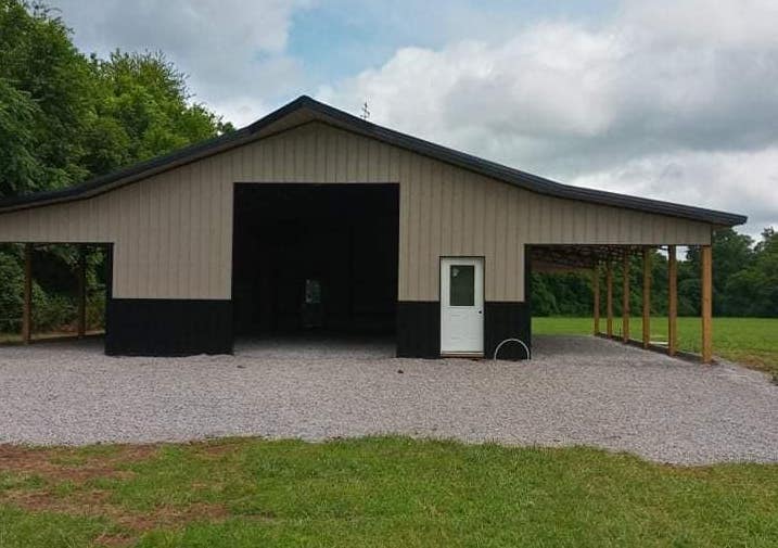 Photo of metal gate with metal electric fence framed with wood posts and rails