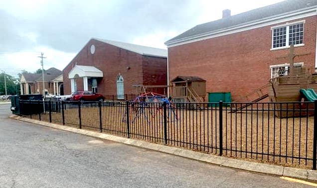 Photo of play yard at a church with black aluminum fencing system