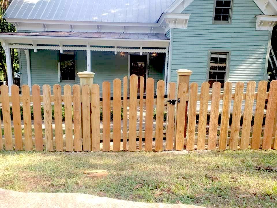 Photo of metal gate with metal electric fence framed with wood posts and rails
