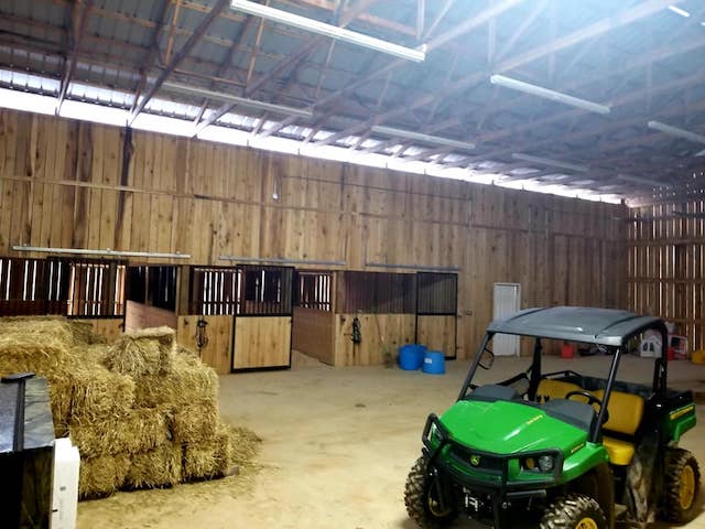 Photo of metal gate with metal electric fence framed with wood posts and rails