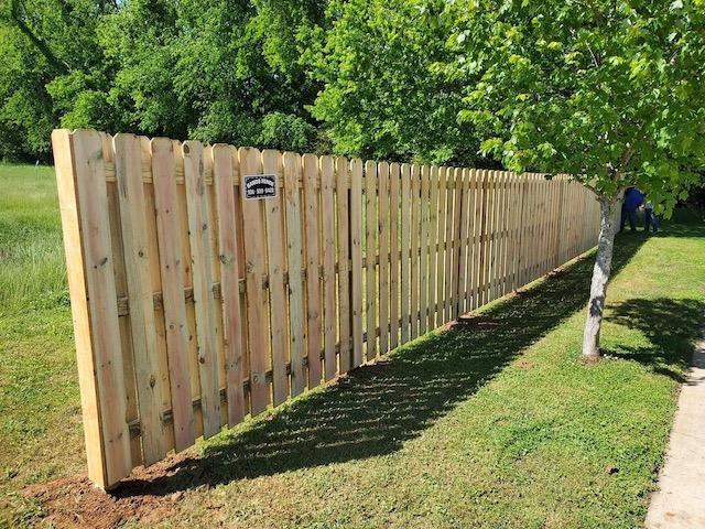 Photo of privacy fence between two properties but not enclosed at the end of the property giving privacy without cutting neighbors off