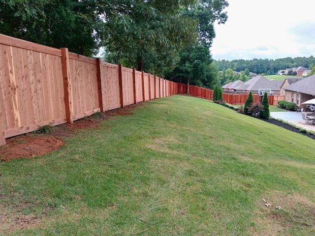 Photo of cedar privacy fence the extends the length of a very long and narrow home property in a subdivision