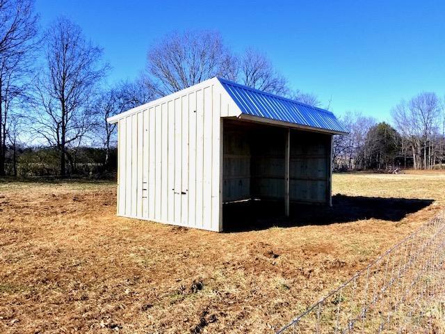 Photo of covered outdoor storage area large enough to store 2 tractors or other farm equipment and suppies