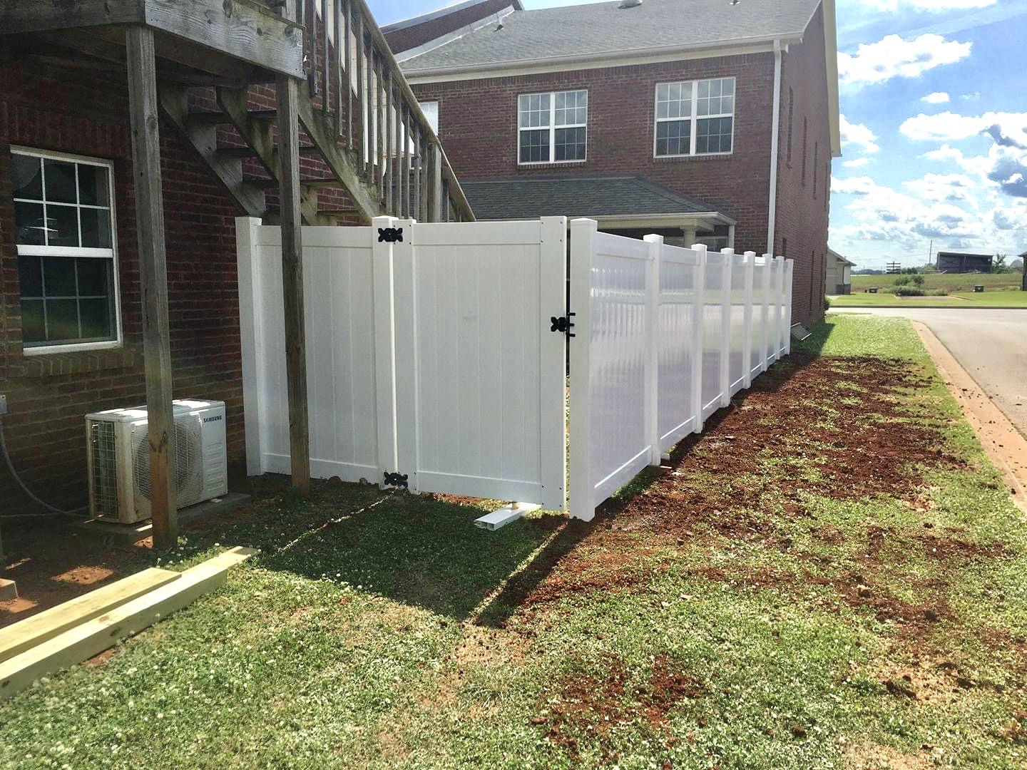 Photo of wood horizontal rail fence with wire mesh between the horizontal slats