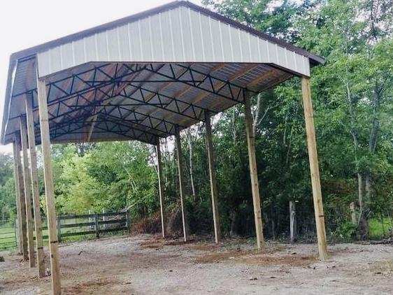 Photo of metal gate with metal electric fence framed with wood posts and rails