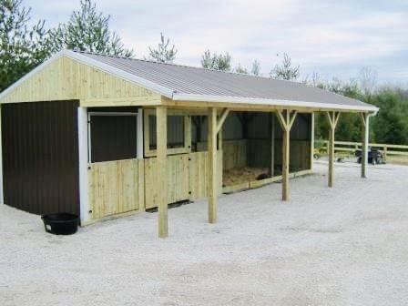 Photo of metal gate with metal electric fence framed with wood posts and rails