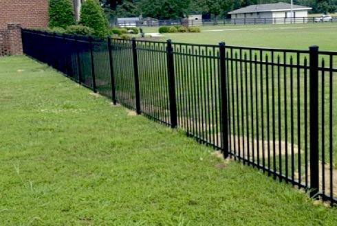 Photo of wood horizontal rail fence with wire mesh between the horizontal slats